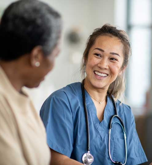 Nurse smiles at adult patient