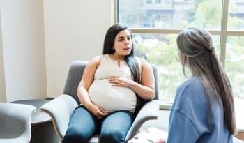 Pregnant person talking with a health care professional