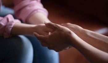 close up of 2 people holding hands