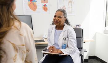 Female healthcare specialist listens to her patient talk about her medical history