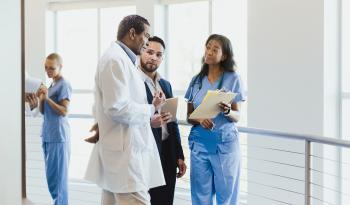 Group of medical doctors and clinical care experts discussing in a hospital setting